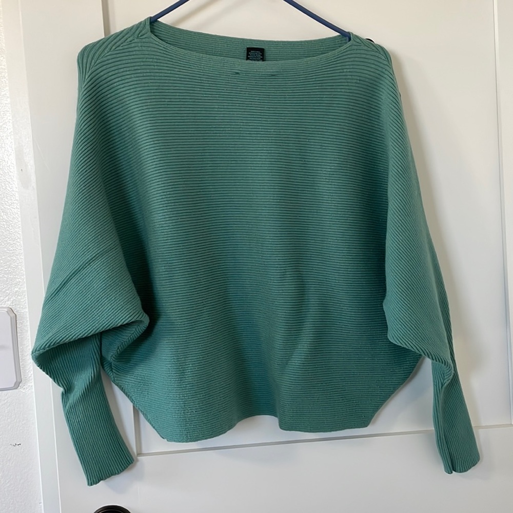 Faith of Zoe teal bat wing shirt with black buttons on left sleeve